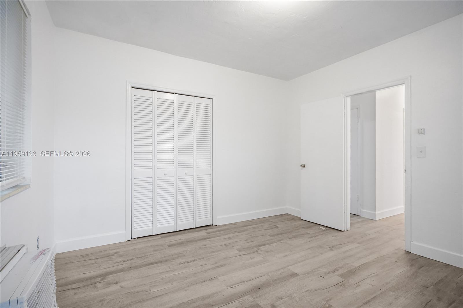 710 82nd Street, Unit 4 Miami Beach, FL 33141 - Photo 29 of 33 a view of an empty room with wooden floor