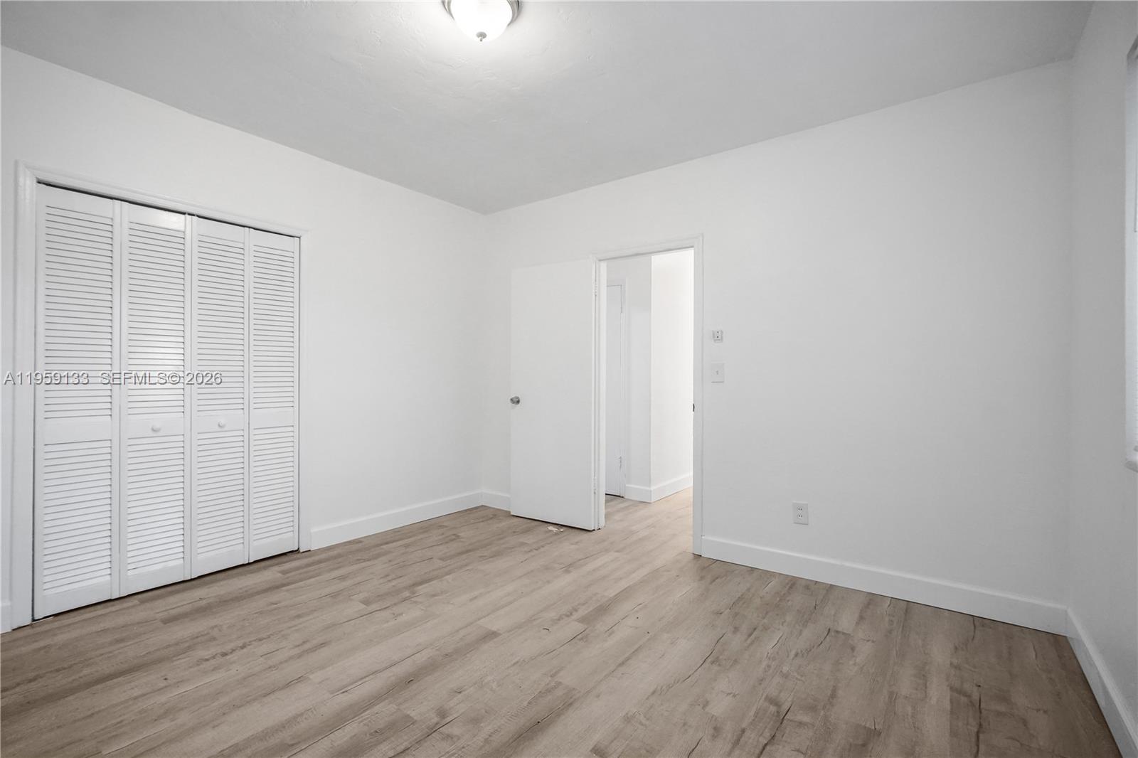 710 82nd Street, Unit 4 Miami Beach, FL 33141 - Photo 30 of 33 an empty room with wooden floor