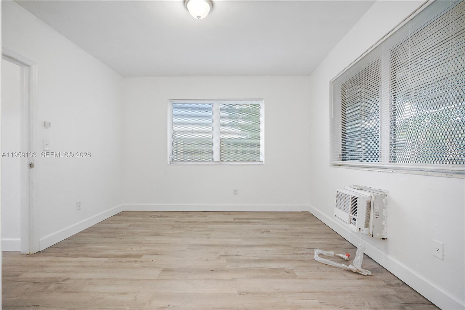 710 82nd Street, Unit 4 Miami Beach, FL 33141 - Photo 32 of 33 wooden floor in an empty room with a window