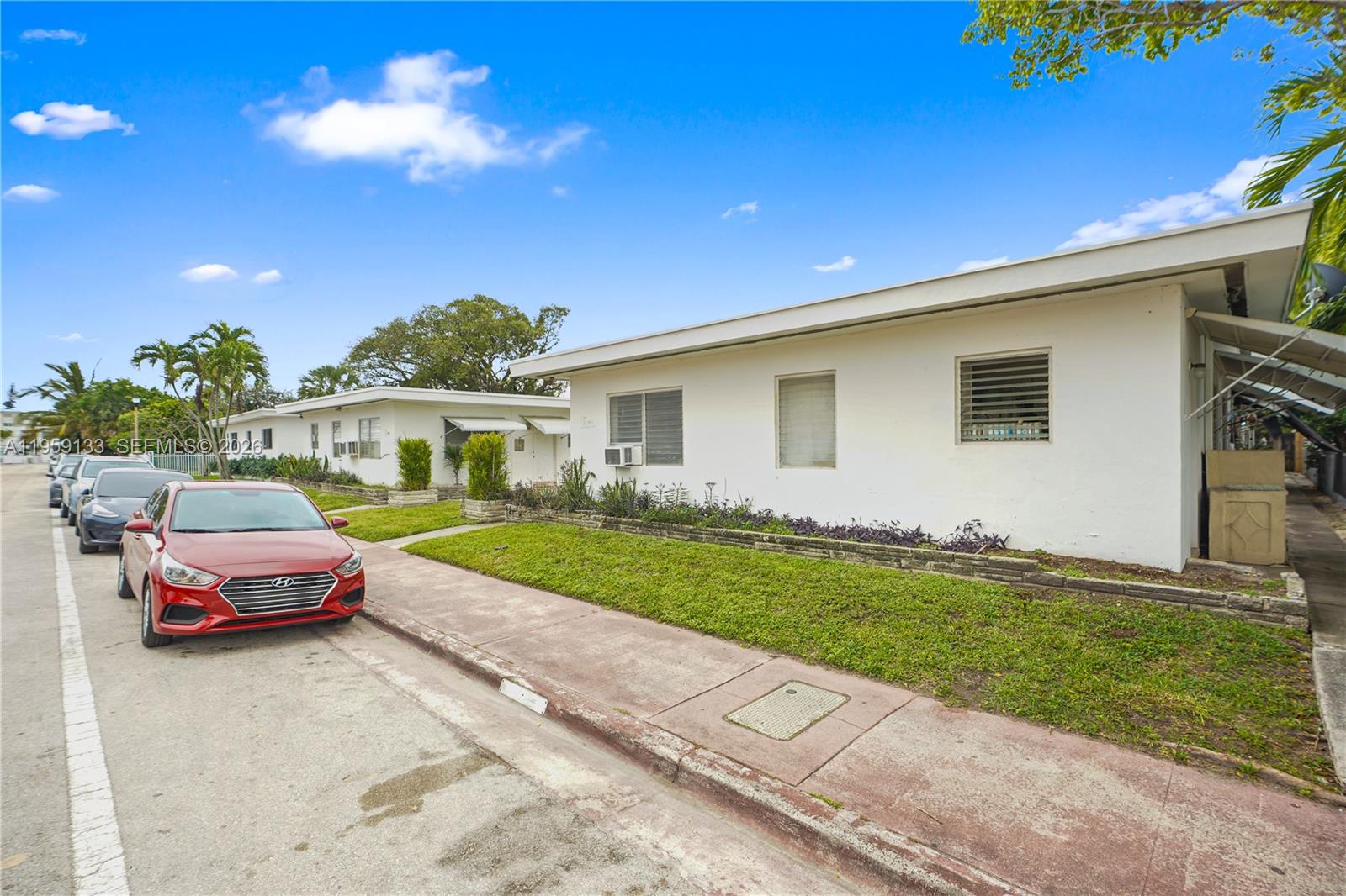 710 82nd Street, Unit 4 Miami Beach, FL 33141 - Photo 4 of 33 a front view of a house with a garden and yard