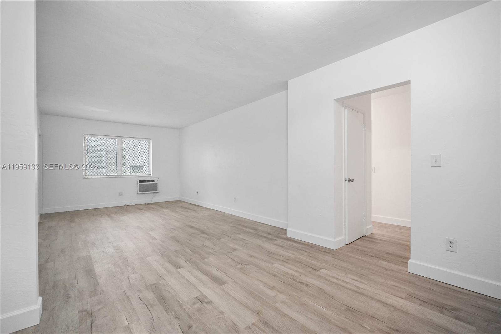 710 82nd Street, Unit 4 Miami Beach, FL 33141 - Photo 7 of 33 an empty room with wooden floor & windows
