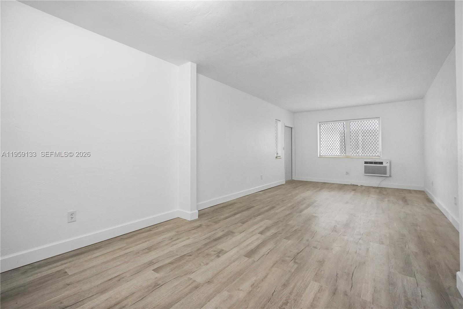 710 82nd Street, Unit 4 Miami Beach, FL 33141 - Photo 8 of 33 a view of empty room with wooden floor and fan