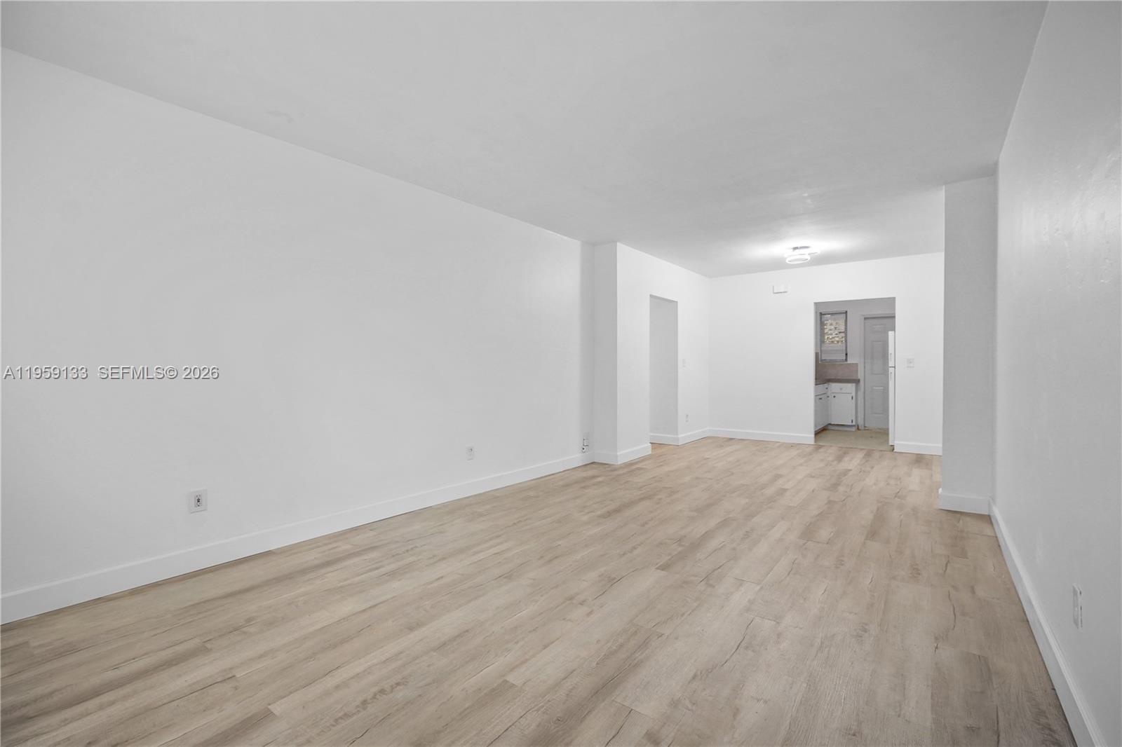 710 82nd Street, Unit 4 Miami Beach, FL 33141 - Photo 9 of 33 a view of an empty room and wooden floor