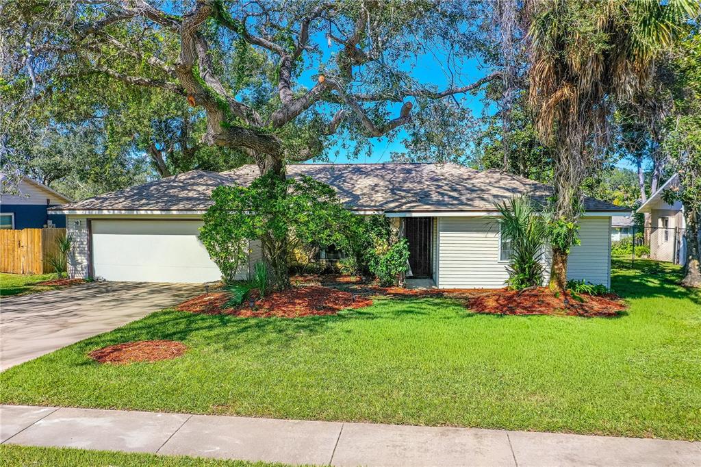 693 Reillys Road Port Orange, FL 32127 - Photo 1 of 31 a front view of a house with a yard and tree