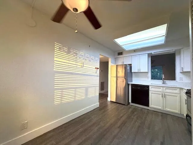 a bathroom with a toilet a sink a mirror and shower