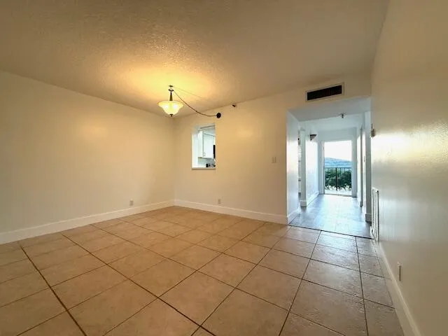 a view of a hallway with wooden floor and stairs