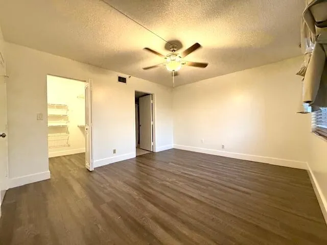 a view of a city with lawn chairs under an umbrella