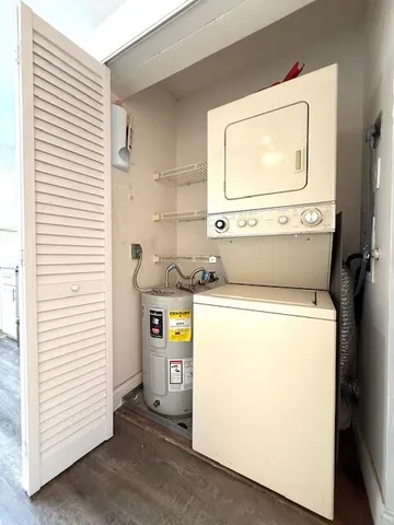a view of a hallway with wooden floor and windows