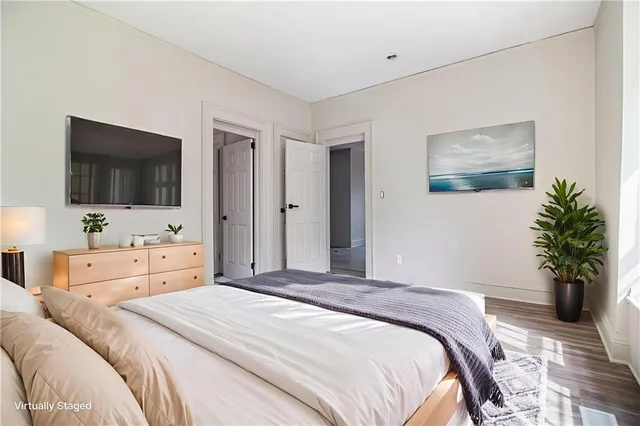 a bedroom with a bed and a flat screen tv