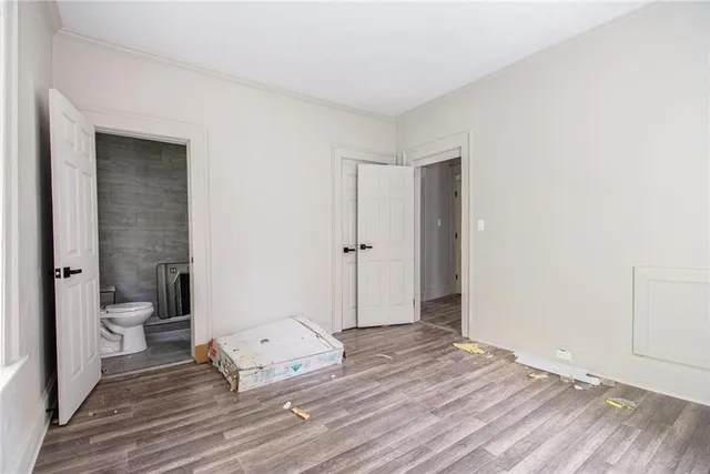 a view of a bedroom with a hardwood floor and a sink