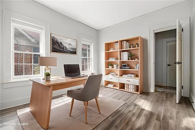 a workspace with wooden floor and a window