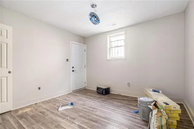 a view of a room with wooden floor and window