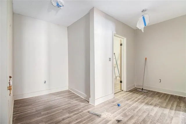 a view of a room with wooden floor