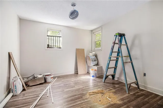 a view of a room with wooden floor and windows