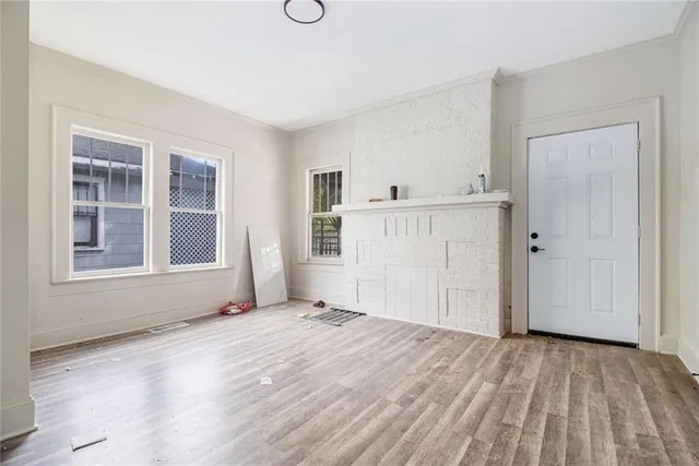 a view of empty room with wooden floor and windows