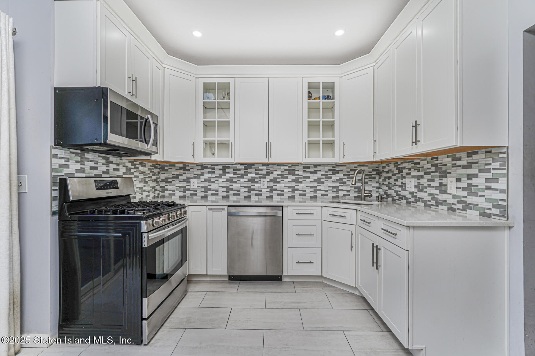 41 Crown Court Staten Island, NY 10312 - Photo 11 of 34 a kitchen with stainless steel appliances granite countertop a stove sink and cabinets