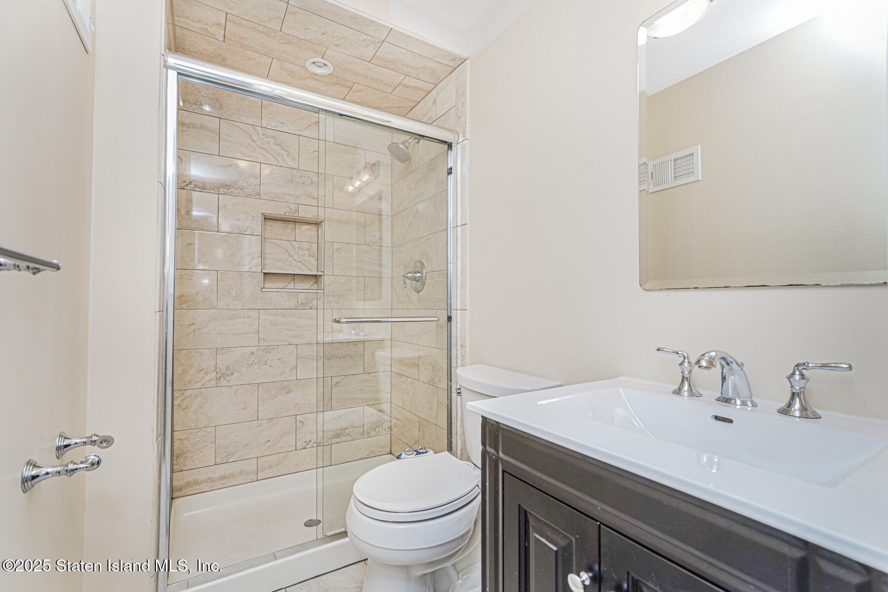 41 Crown Court Staten Island, NY 10312 - Photo 15 of 34 a bathroom with a sink a toilet and shower