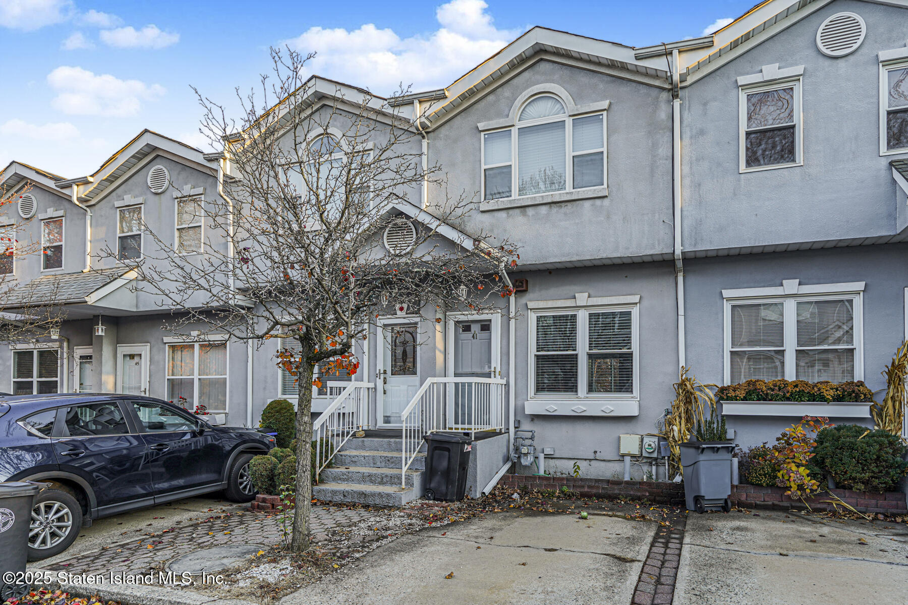 41 Crown Court Staten Island, NY 10312 - Photo 2 of 34 a front view of a house with a garden and furniture