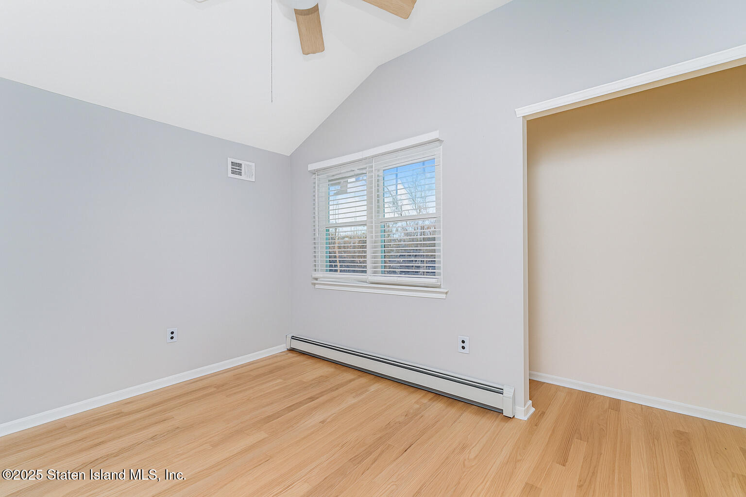 41 Crown Court Staten Island, NY 10312 - Photo 23 of 34 a view of an empty room with wooden floor and a window