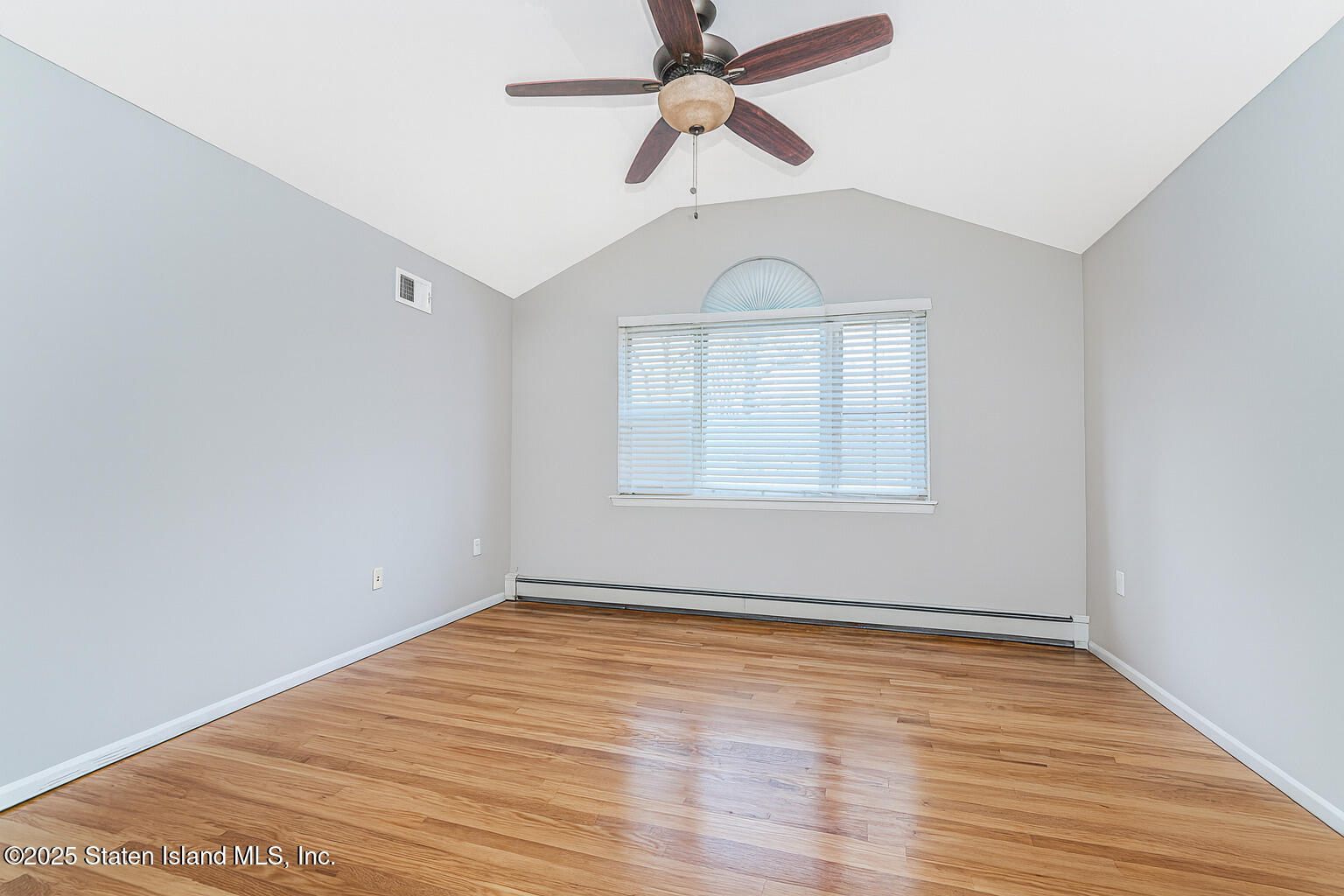 41 Crown Court Staten Island, NY 10312 - Photo 25 of 34 an empty room with wooden floor fan and windows