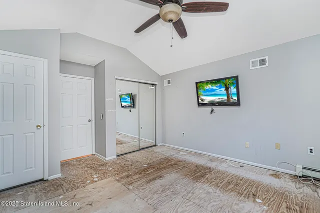 a view of a livingroom with a ceiling fan and entryway