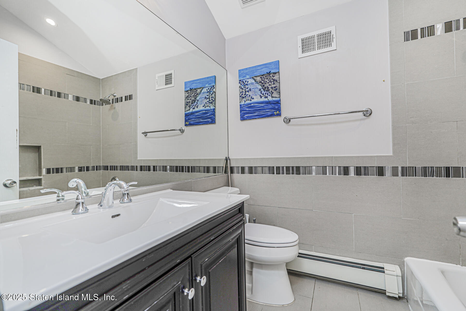 41 Crown Court Staten Island, NY 10312 - Photo 28 of 34 a bathroom with a sink a toilet and mirror