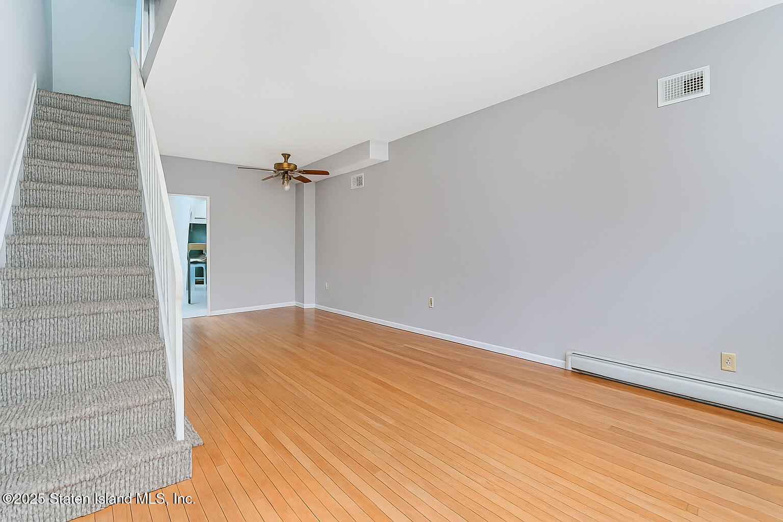 41 Crown Court Staten Island, NY 10312 - Photo 4 of 34 a view of a room with wooden floor and white walls