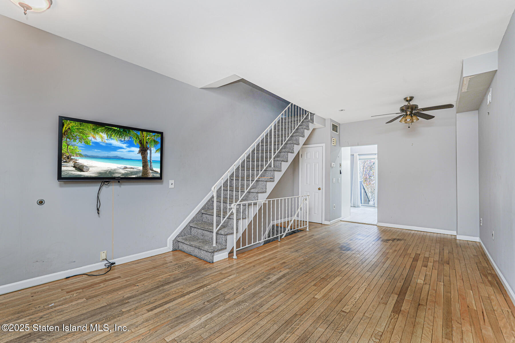 41 Crown Court Staten Island, NY 10312 - Photo 6 of 34 a view of empty room with wooden floor and fan