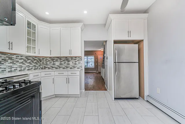 a kitchen with a refrigerator and a stove