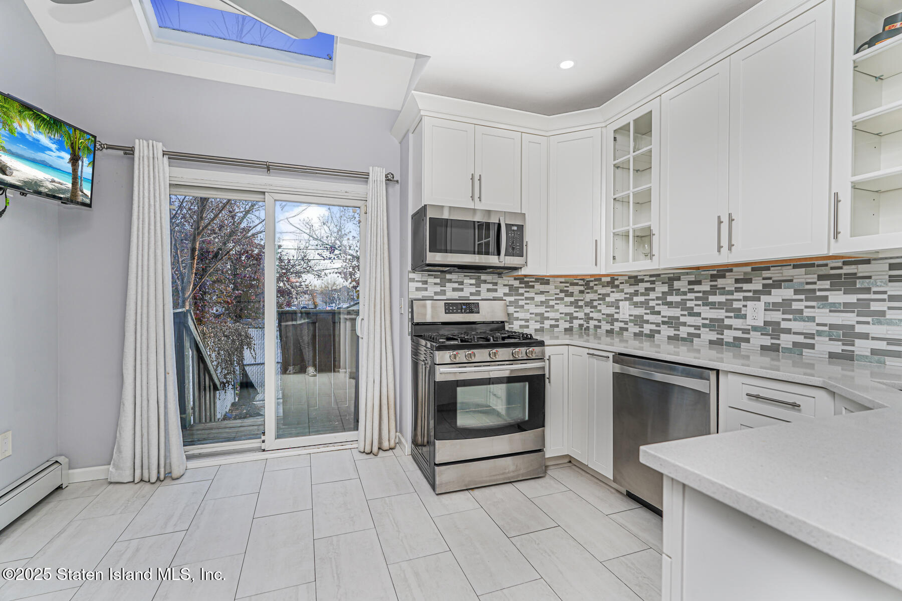 41 Crown Court Staten Island, NY 10312 - Photo 10 of 34 a kitchen with granite countertop a stove top oven microwave and a sink