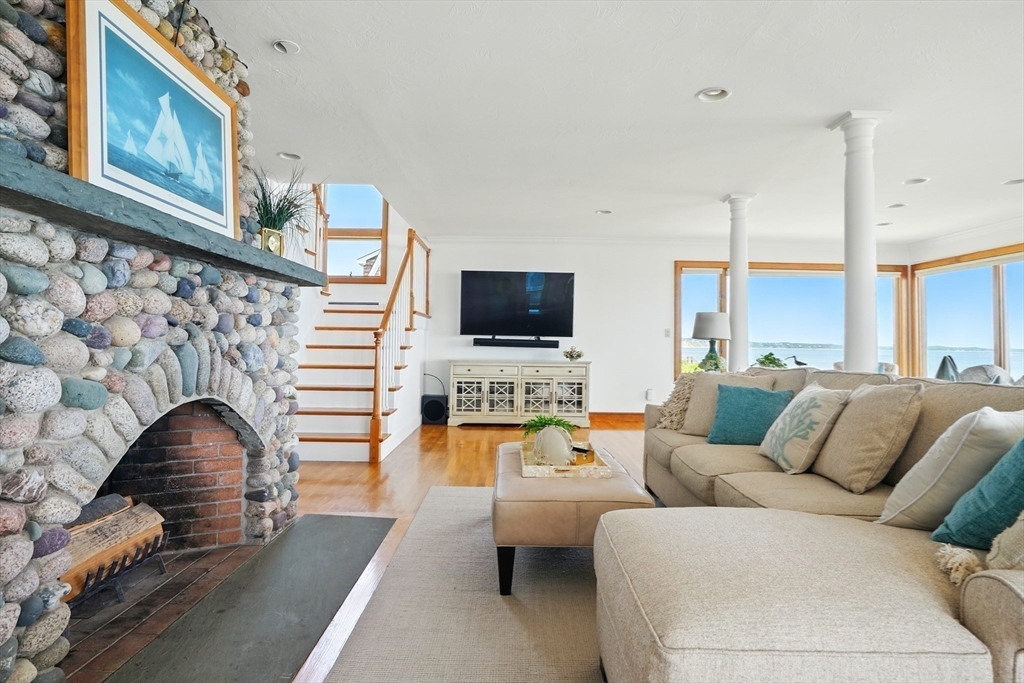 45 Phillips Road Bourne, MA 02562 - Photo 15 of 42 a living room with furniture flat screen tv and a fireplace