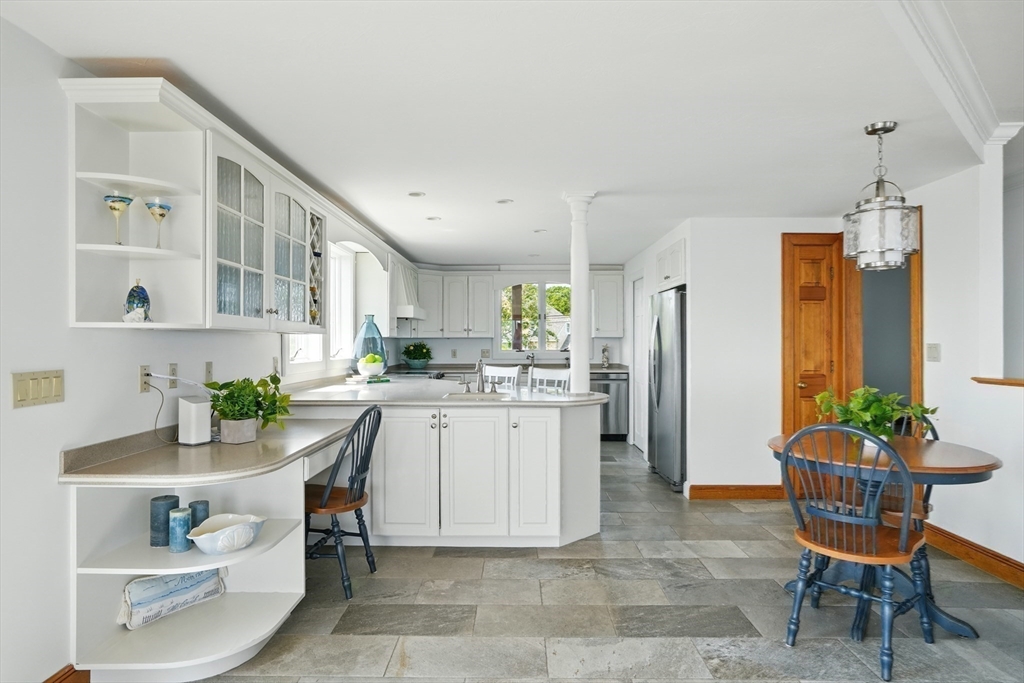 45 Phillips Road Bourne, MA 02562 - Photo 19 of 42 a kitchen with a refrigerator and table