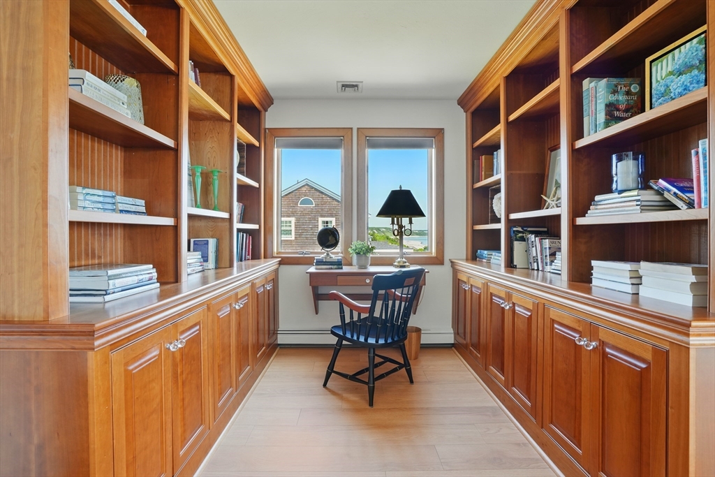 45 Phillips Road Bourne, MA 02562 - Photo 27 of 42 a dining room with furniture and a floor to ceiling window