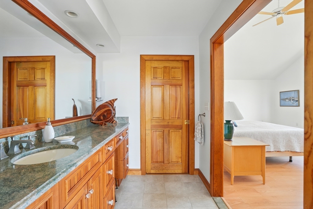 45 Phillips Road Bourne, MA 02562 - Photo 29 of 42 a bathroom with a granite countertop sink and a mirror