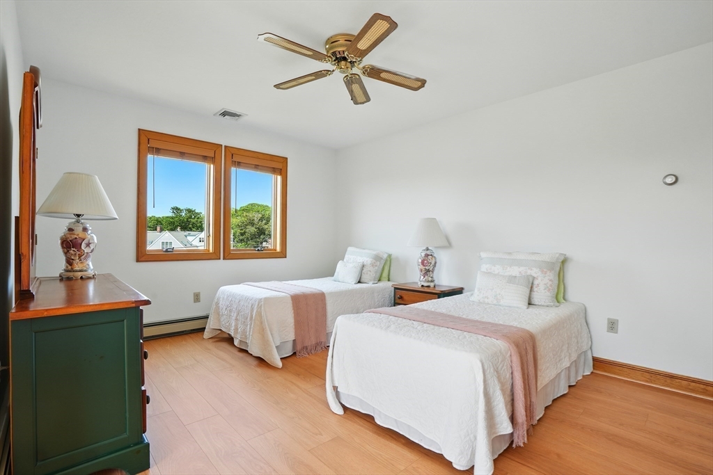 45 Phillips Road Bourne, MA 02562 - Photo 31 of 42 a bedroom with two beds and a chandelier