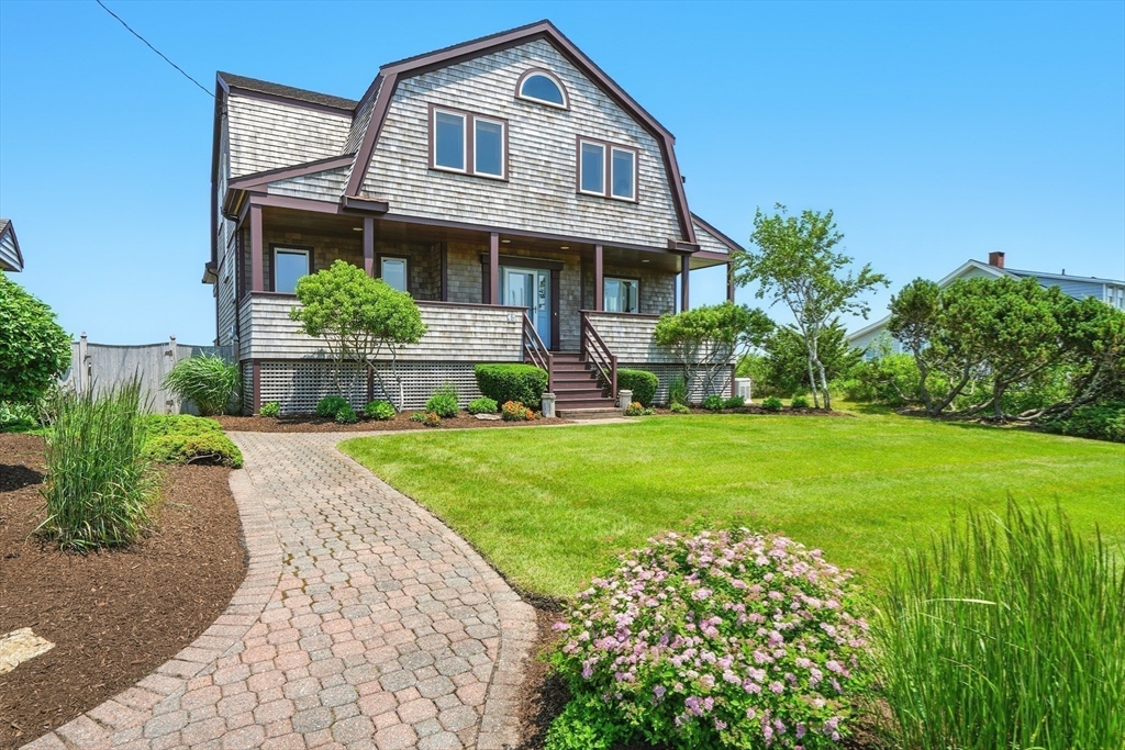 45 Phillips Road Bourne, MA 02562 - Photo 7 of 42 a front view of a house with a yard and potted plants