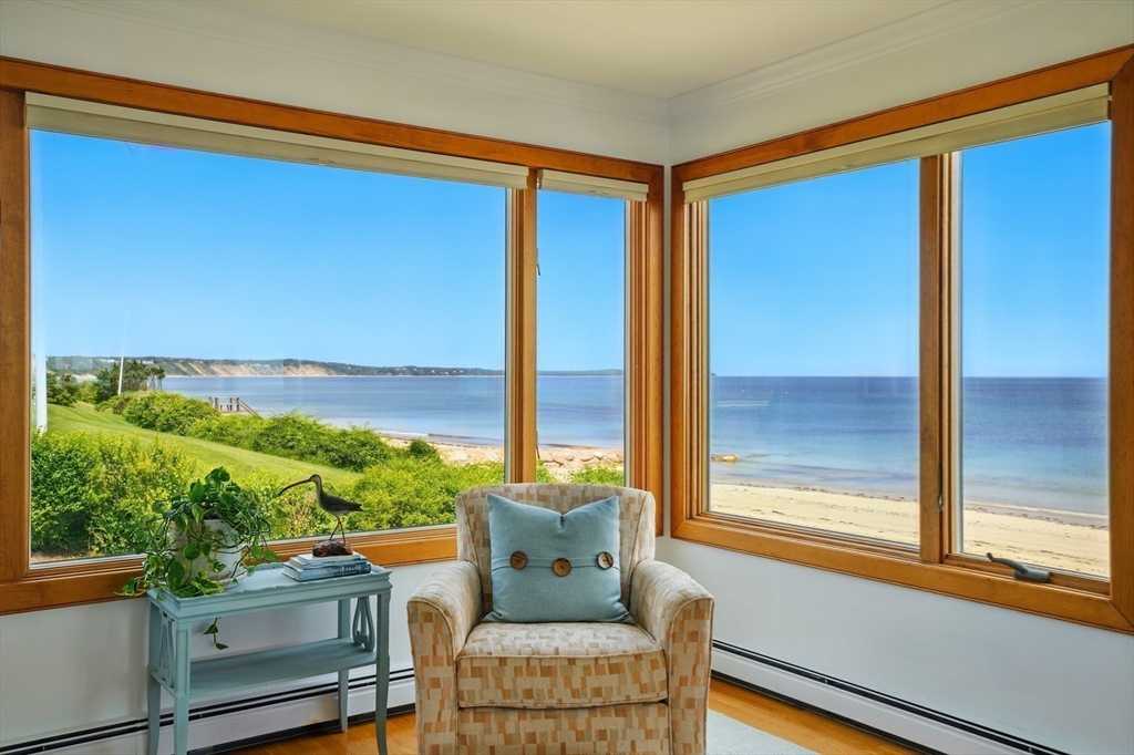 45 Phillips Road Bourne, MA 02562 - Photo 9 of 42 a living room with furniture and a floor to ceiling window
