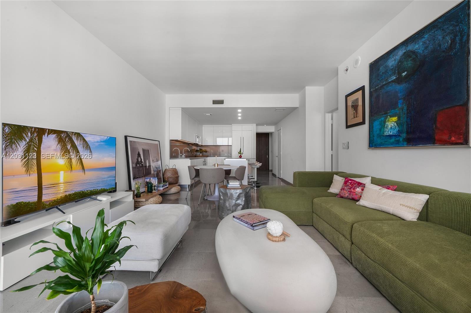 88 Southwest 7th Street, Unit 3208 Miami, FL 33130 - Photo 9 of 16 a living room with furniture and a flat screen tv