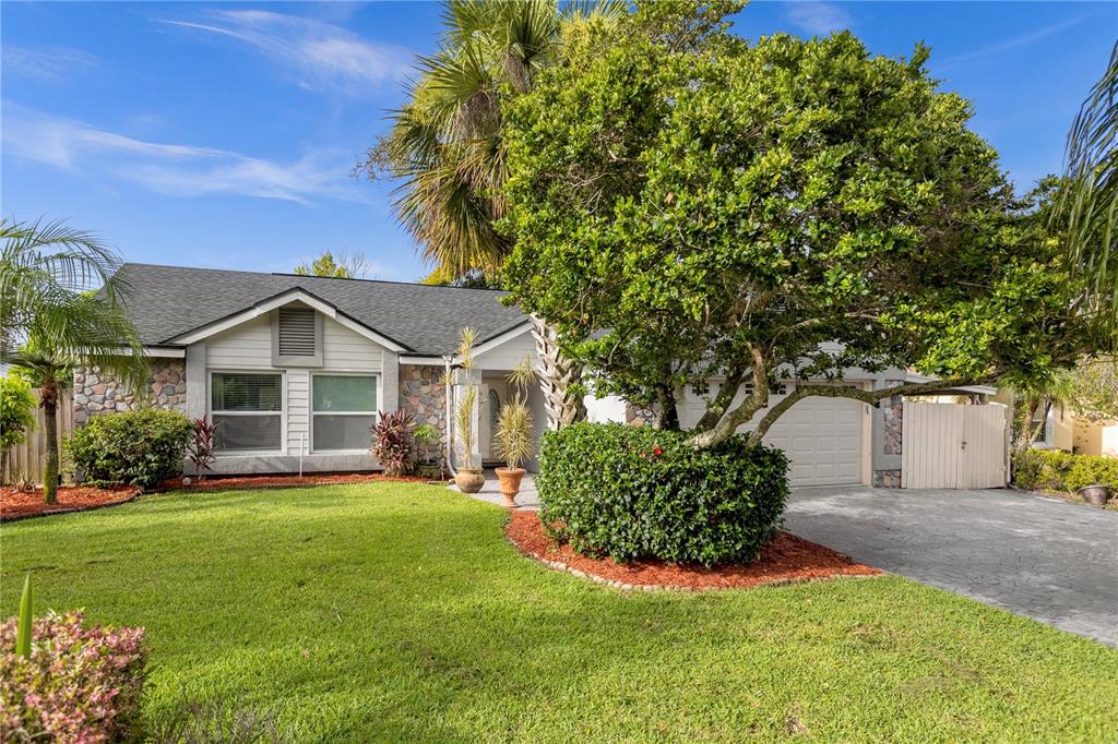 2244 Rio Pinar Lakes Boulevard Orlando, FL 32822 - Photo 1 of 1 a front view of a house with a yard and garage