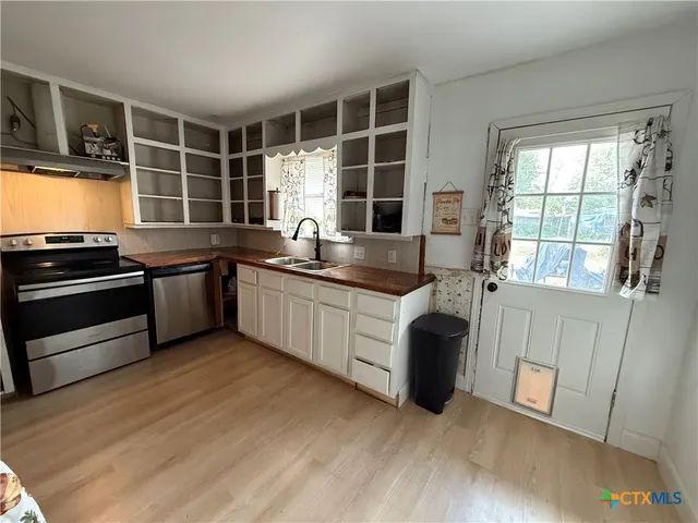 a kitchen that has a sink and a stove