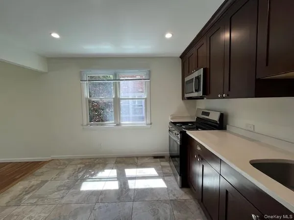 a kitchen that has a sink and a stove in it