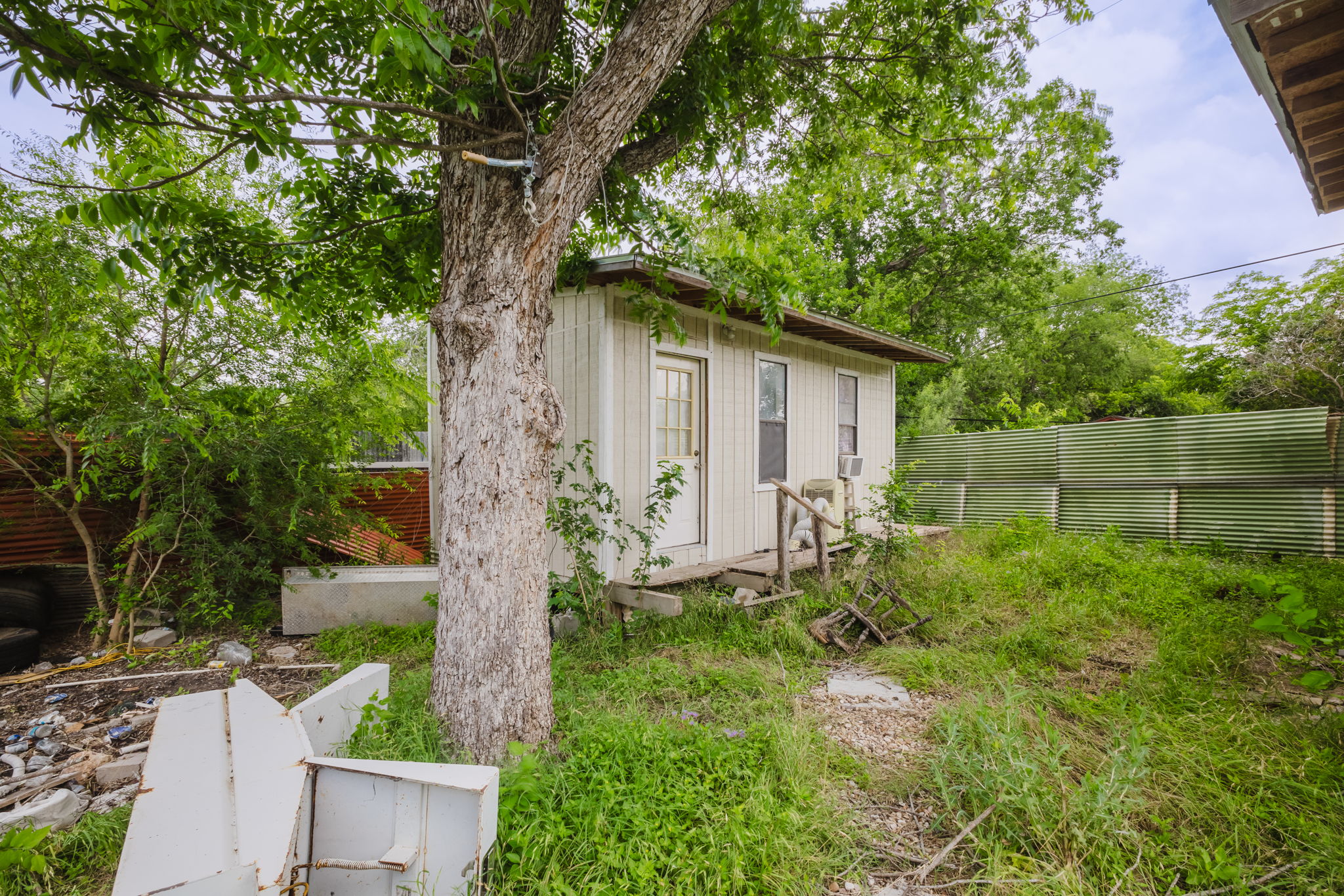 6803 Viewing Place Austin, TX 78719 - Photo 11 of 20 A quaint detached structure, ideal for storage or a compact retreat, nestled among abundant greenery.
