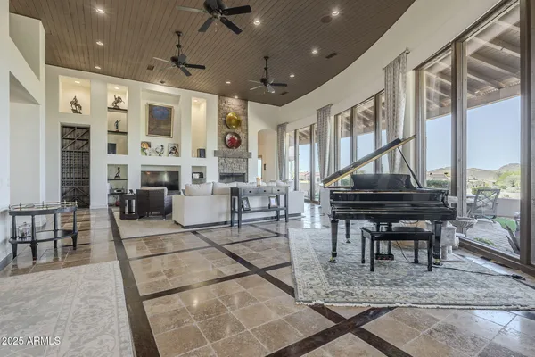 a large white kitchen with granite countertop a large stove a sink a refrigerator and white cabinets
