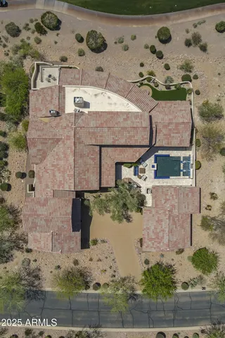 an aerial view of a house with a yard