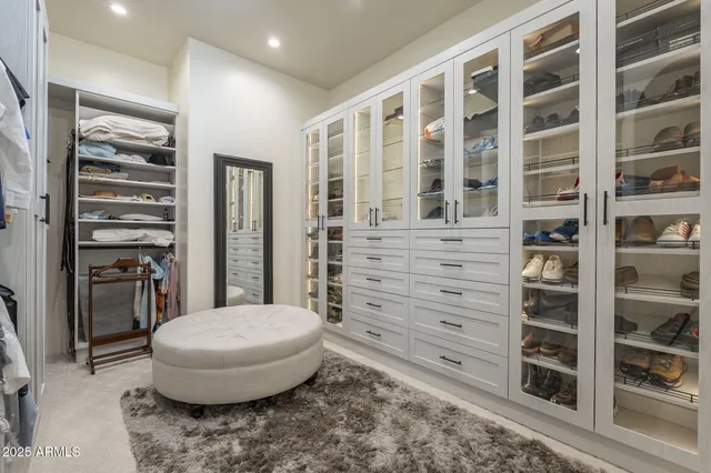 a kitchen with a refrigerator a sink and chairs