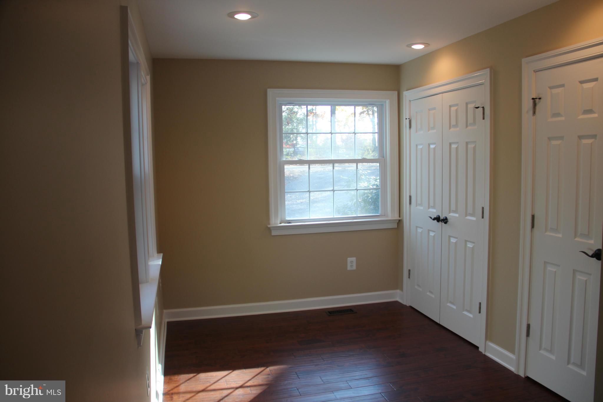9504 Mountjoy Road Marshall, VA 20115 - Photo 14 of 27 an empty room with wooden floor and windows