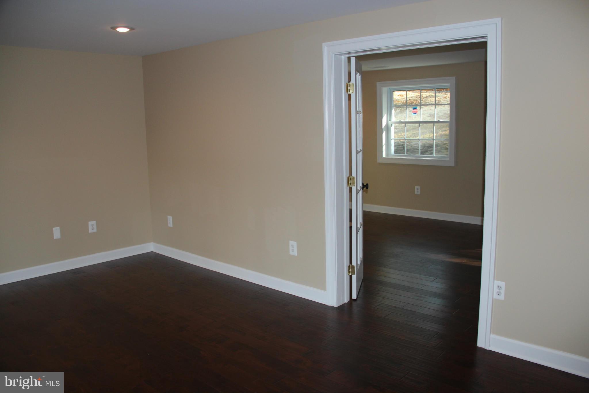 9504 Mountjoy Road Marshall, VA 20115 - Photo 22 of 27 an empty room with wooden floor and a window