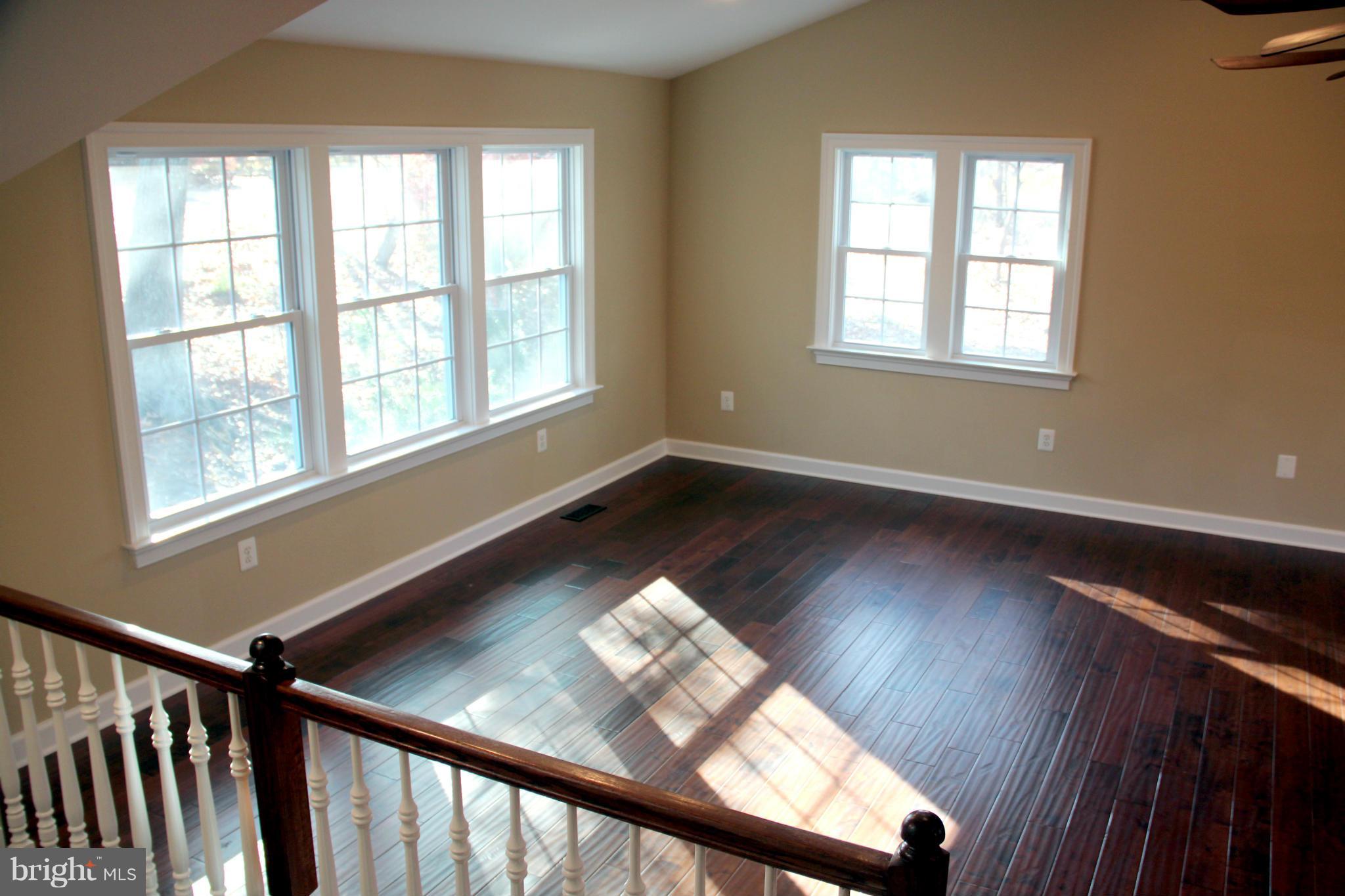 9504 Mountjoy Road Marshall, VA 20115 - Photo 8 of 27 a view of an empty room with wooden floor and windows
