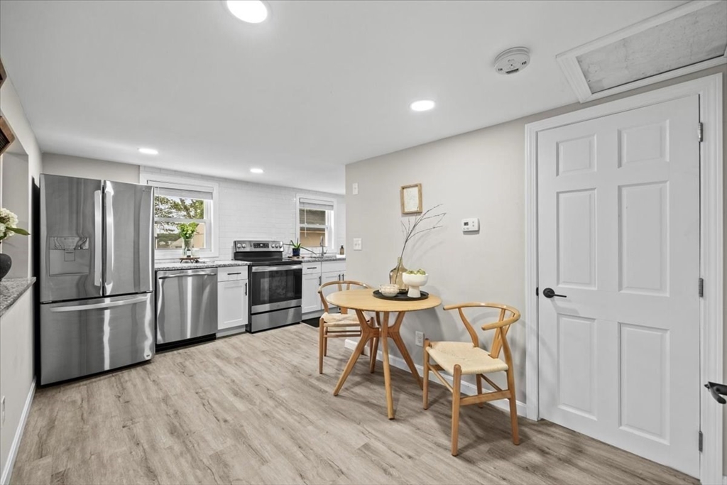 14 Pinehurst Drive Wareham, MA 02571 - Photo 13 of 41 a kitchen with stainless steel appliances a refrigerator a stove a sink dishwasher and white cabinets with wooden floor