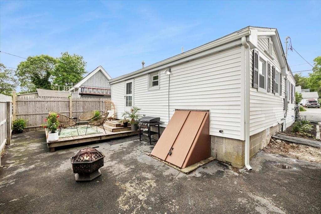 14 Pinehurst Drive Wareham, MA 02571 - Photo 36 of 41 a front view of a house with a chairs and table